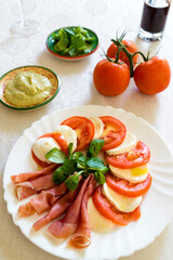 caprese salad with guacamole sauce and tomato