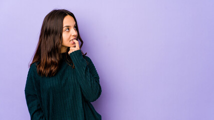Young mixed race hispanic woman isolated looking sideways with doubtful and skeptical expression.