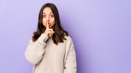 Young mixed race hispanic woman isolated keeping a secret or asking for silence.