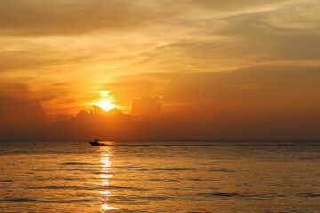 Fototapeta na wymiar Boat Crossing Ocean at Sunset