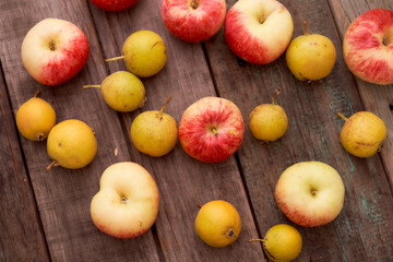 Red apples and small pear lie on a wooden board. Top view.With copy space.