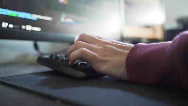 Gamer's Hand, while Playing fps game in his Room