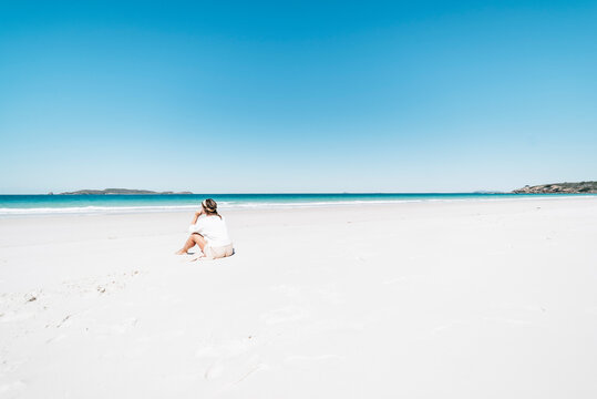 A woman enjoys her holidays on a paradisiac beach in a remote island