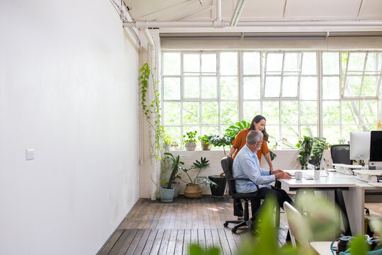 Man and woman meeting in an urban renovated white heritage office space