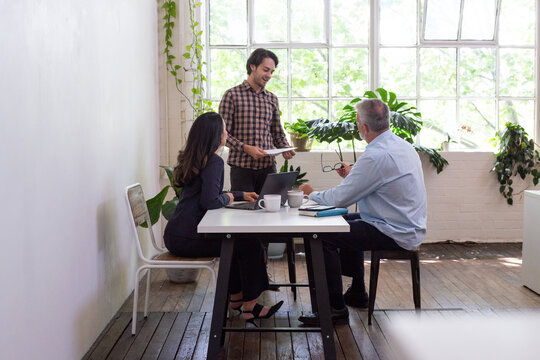 Three people collaborating in an open office