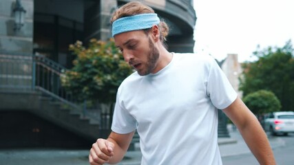 Athletic young sportsman jogging on street then using smartphone virtual futuristic app with fitness activities interacting user interface hologram. Technologies. - Powered by Adobe