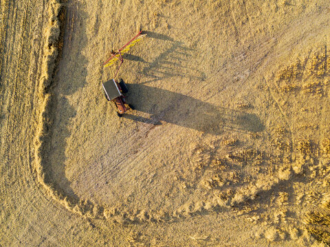 Looking down on a tractor and farm machinery sitting in a paddock