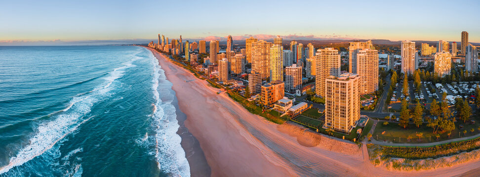 Aerial view at sunrise of high rise buildings along a beach