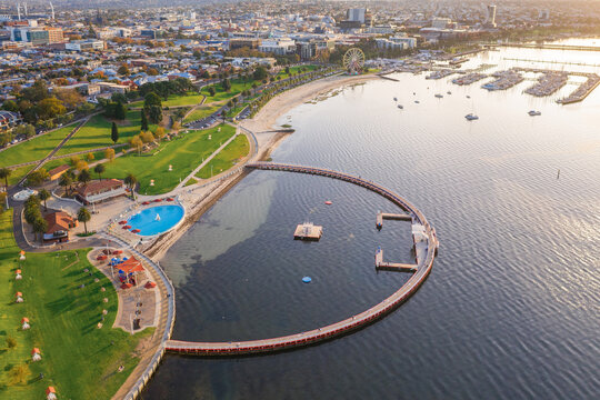 Aerial view of a large circular swimming enclosure along a coastal waterfront