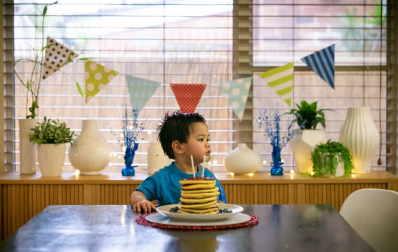 A lucky kid getting a hotcake stack on his second birthday