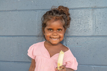Aboriginal girl eating banana