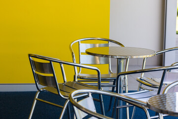 silver chairs and tables in an empty cafe
