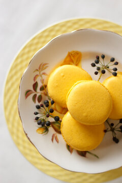 Yellow macarons on cake stand