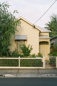 View Of Surburban House Front Gate With Tree In Front Garden