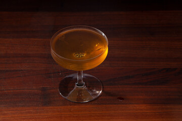 Brooklyn cocktail on a walnut bar top (Rye Whiskey, Dry Vermouth, Maraschino Liqueur)