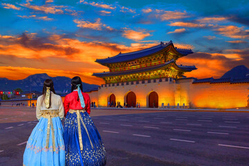 During sunset.the woman in Korean national dress at front gyeongbokgung Palace , seoul, south korea