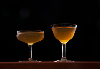 Brooklyn cocktails served up.  Vintage glassware on a wooden board, black background