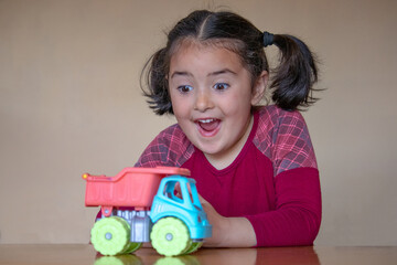 White girl playing with toy truck