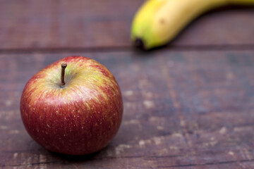 Healthy snack red apple and banana with copy space 