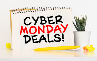 Top view of Cyber Monday Sale text on white picture frame with black gift box