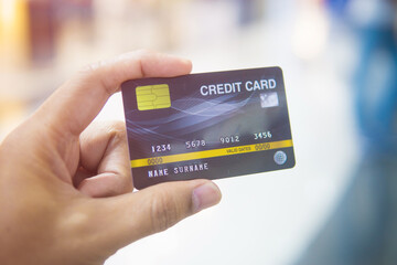 Close up of man hand holding credit card for shopping.