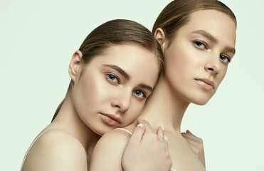 Fototapeta premium Two beautiful sensual young girls with clean fresh face skin