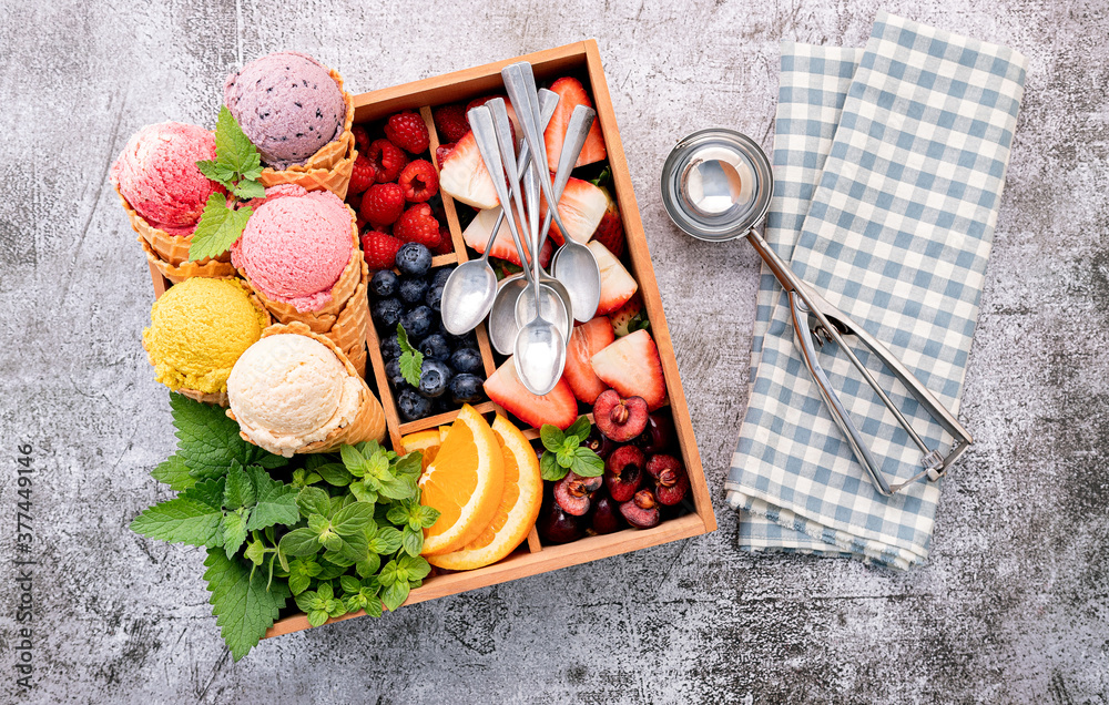 Poster Various of ice cream flavor in cones with berries in wooden box setup on concrete background . Summer and Sweet menu concept.