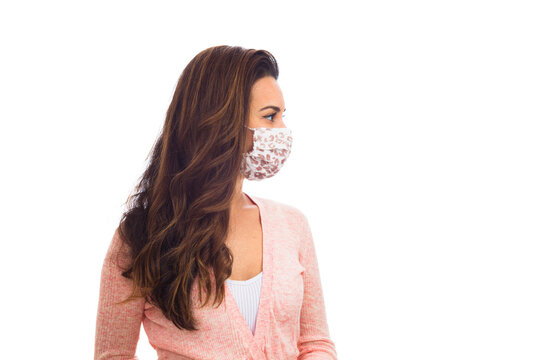 Beautiful Young Woman Wearing A Protective Mask Isolated On A White Background