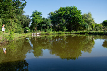 Fototapeta na wymiar Romania, Bistrita, Paradisul Verde Guesthouse, pontoon on the lake, 2020