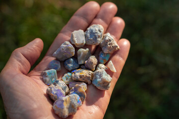 Lightning Ridge black opal rough in a hand