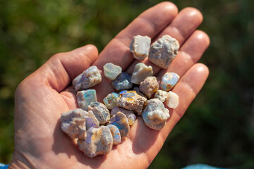 Lightning Ridge black opal rough in a hand