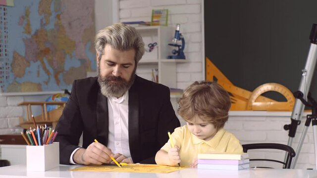 Child preschool and teacher learning in classrom. Child home education. School kids.