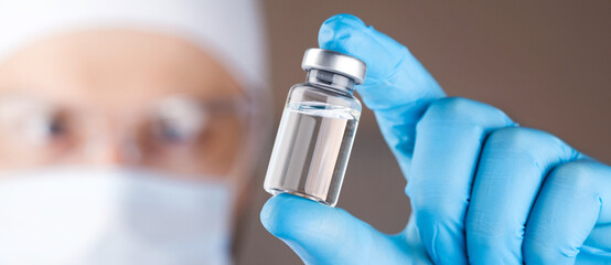 Doctor holding a viol with vaccine against corona virus.