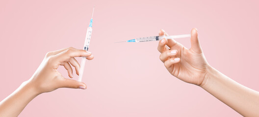 Hand holding syringe with vaccine against corona virus.