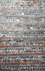 Ancient wall of stone and brick, lined with different structure and sequence. For the whole background of the photo