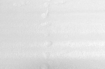 Plastic foam white sheet texture abstract background blurred.