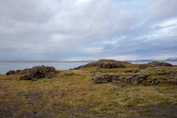Fototapeta na wymiar Icelandic landscape with rocks green moss and clouds
