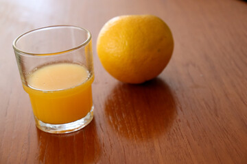 glass of orange juice and orange