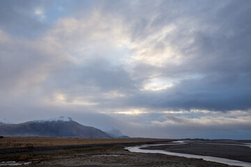 clouds above icelandic landscape at blue hour