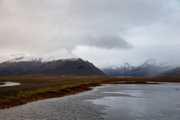 clouds over the snowy mountains in iceland