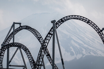 Roller coaster railqay track with view of Mt. Fuji or Fuji-san, Japan.