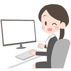 PCを操作するスーツの女性