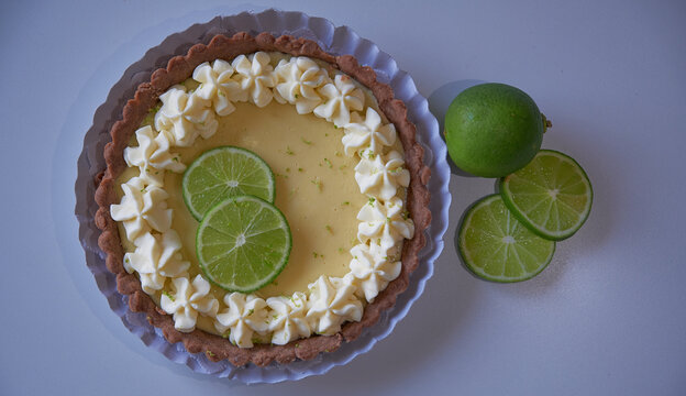 key lime pie. lime pie and whipped cream with sabl&eacute; dough and garnished with slices and lime zest