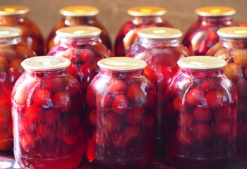 Preservation for the winter is in the pantry or cellar.Large glass jars with home preservation of plum compote.