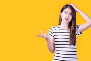 Portrait of beautiful asian young woman, on yellow  color background with copy space. Human face expressions, emotions feelings, body language,beauty and fashion concept.