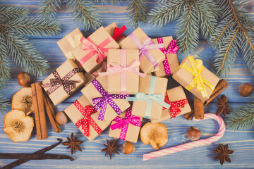 Wrapped gifts with ribbons for Christmas, spices and spruce branches. Vintage photo