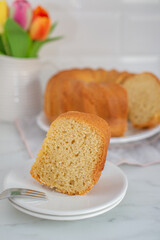 Fresh vanilla bundt cake on a wooden cutting board