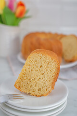 Fresh vanilla bundt cake on a wooden cutting board
