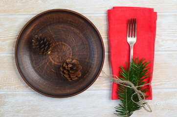 Christmas background with copy space for text tree branch  clay plate and silver fork with napkin....