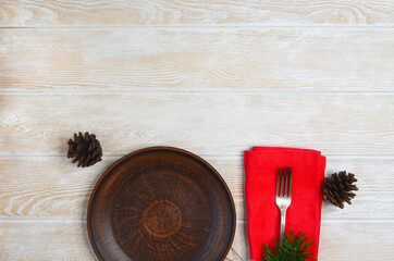 Christmas background with copy space for text tree branch  clay plate and silver fork with napkin....